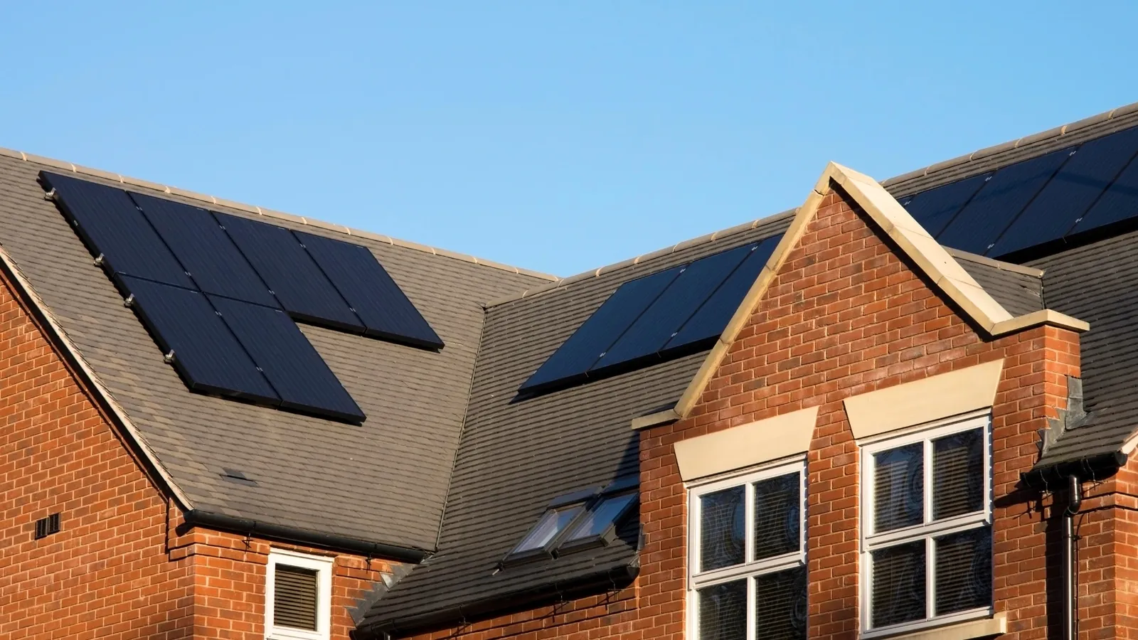 Solar panels installed on the roof of a brick home